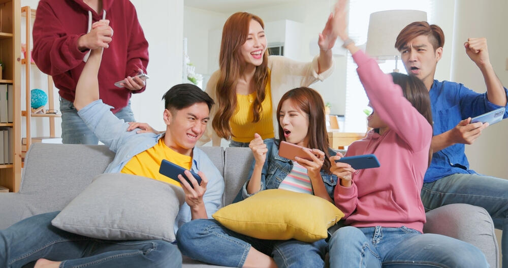 A bunch of people playing Web3 Games on mobile